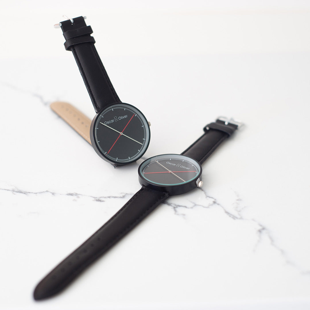 Two Classic Black Watches. One upright. One Flat. Naughty or Nice Combo